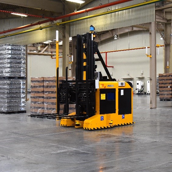 yellow automated guided vehicle forklift in a warehouse setting