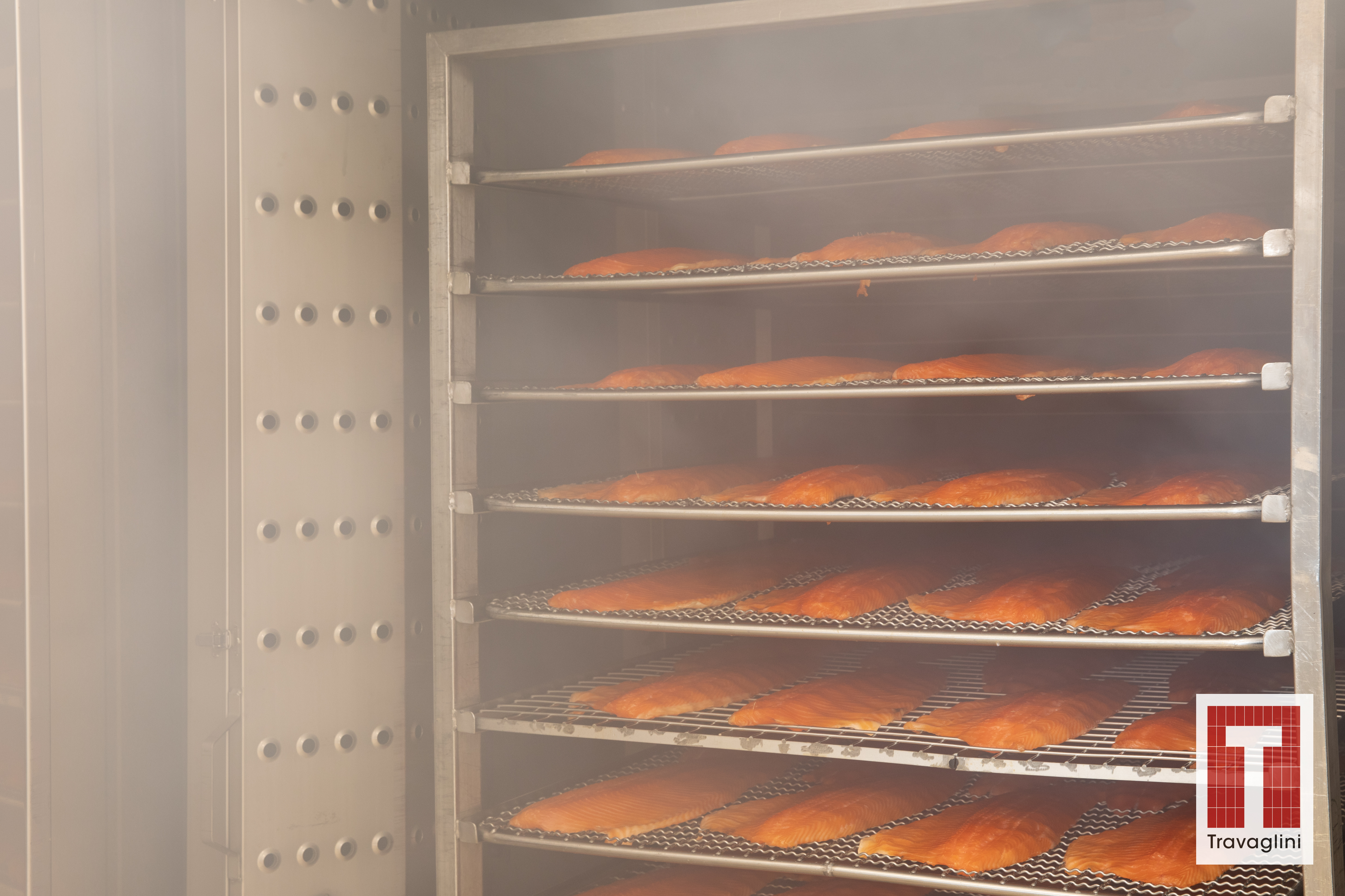 shelves of fish fillet coming out of a Travaglini smoke chamber