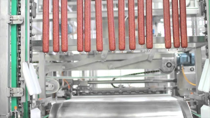 14 sticks of salami on an automated production line